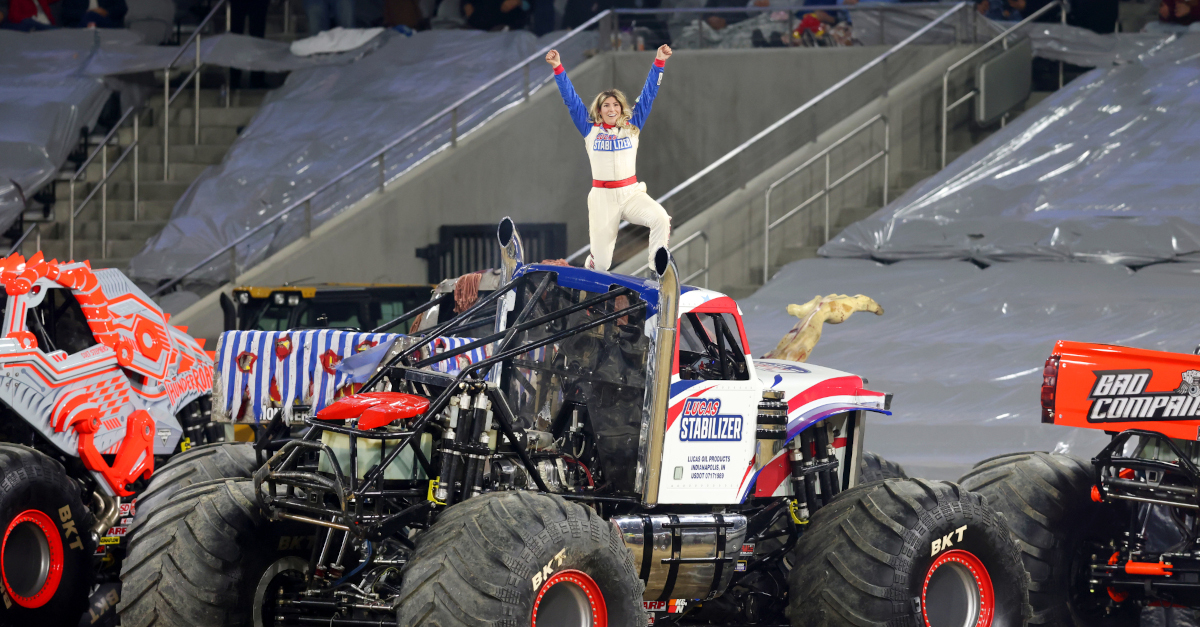 Cynthia Gauthier standing on top of the Lucas Stabilizer Monster Jam truck